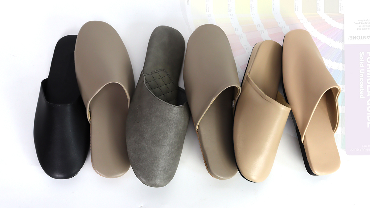 Collection of custom mule slippers in various colors (grey, beige, tan) by JNP Footwear, showcasing material options