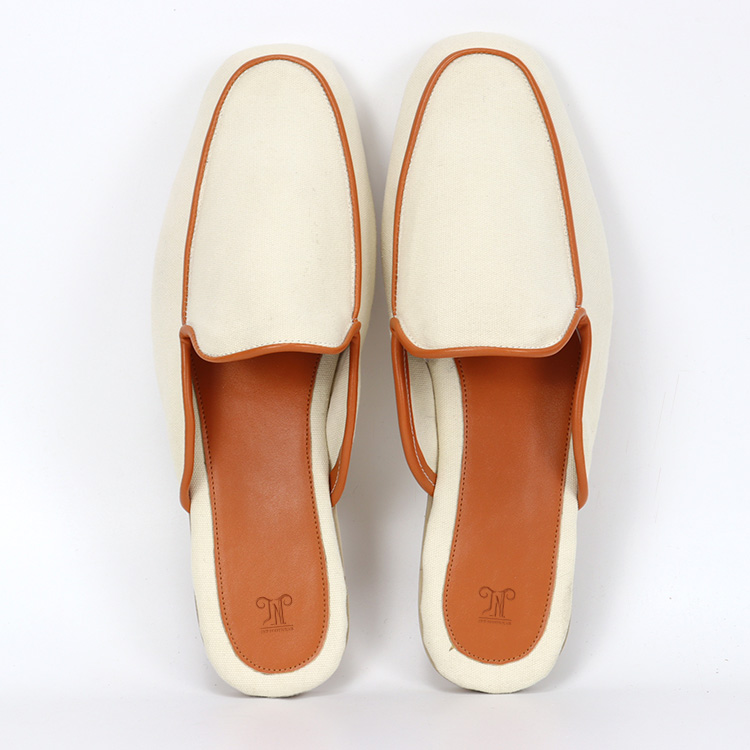 Top view of elegant two-tone custom slippers in cream and tan leather-like material by JNP Footwear