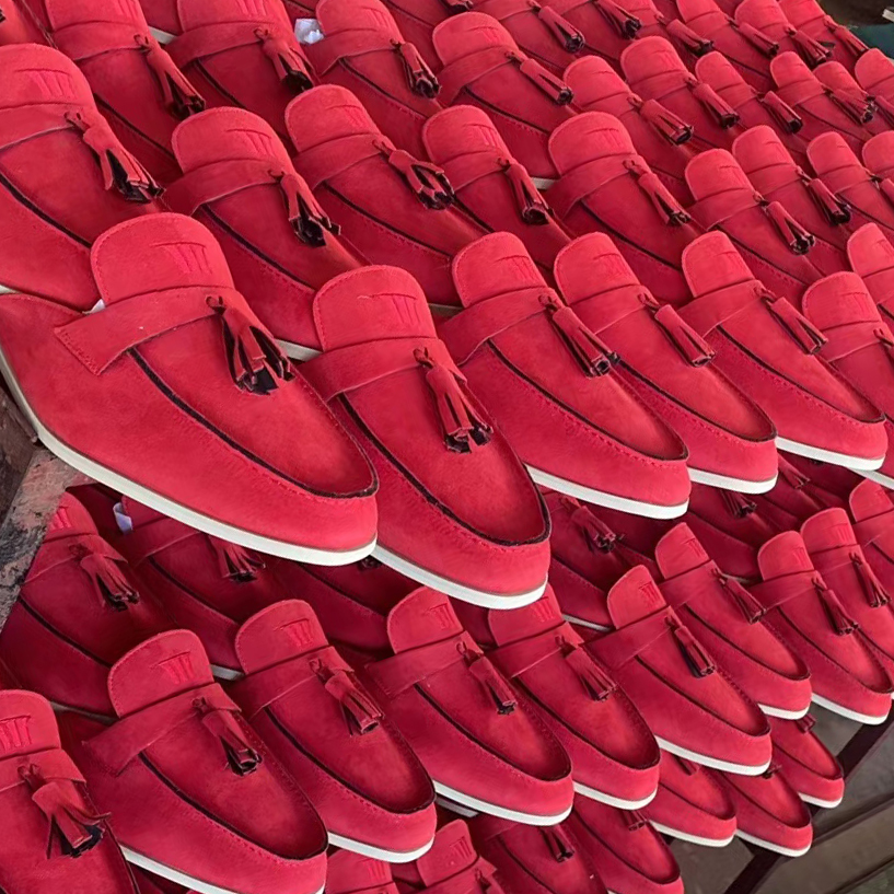 Vibrant red custom suede loafer-style slippers with tassels, mass-produced by JNP Footwear for B2B
