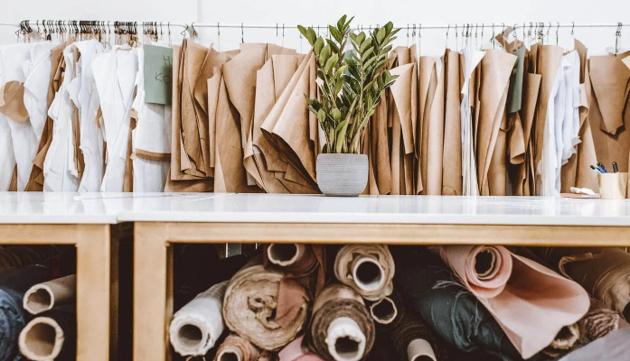 Fashion design studio with fabric rolls and paper patterns